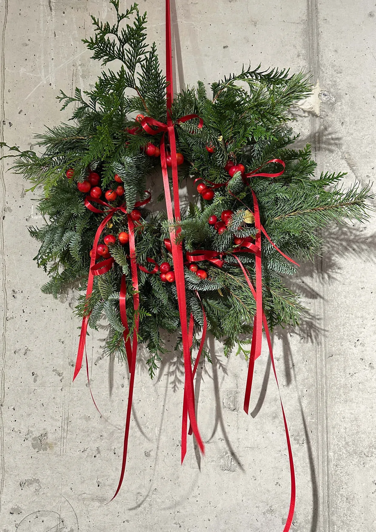 Christmas wreath with fir tree and red ribbon