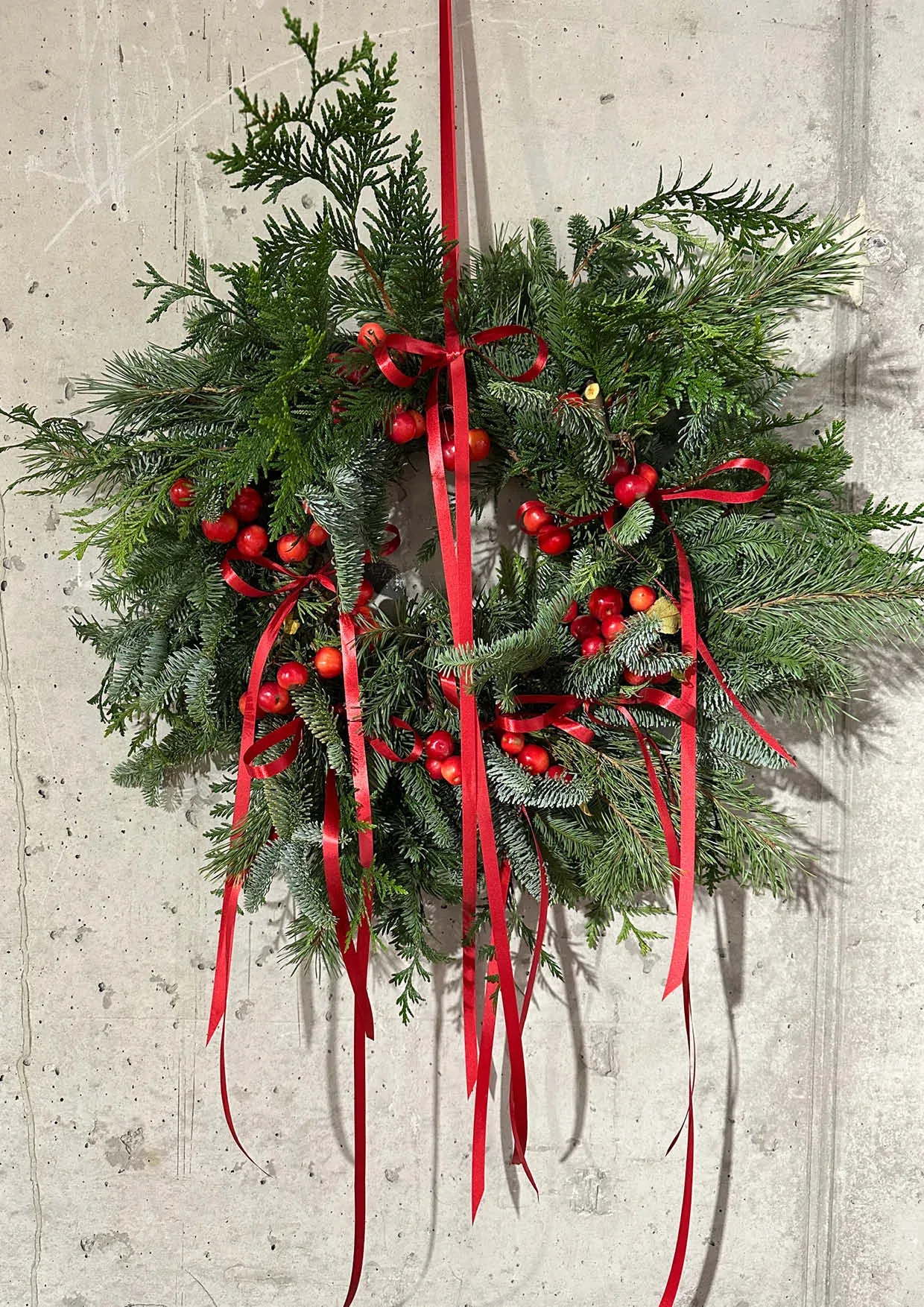Christmas wreath with fir tree and red ribbon