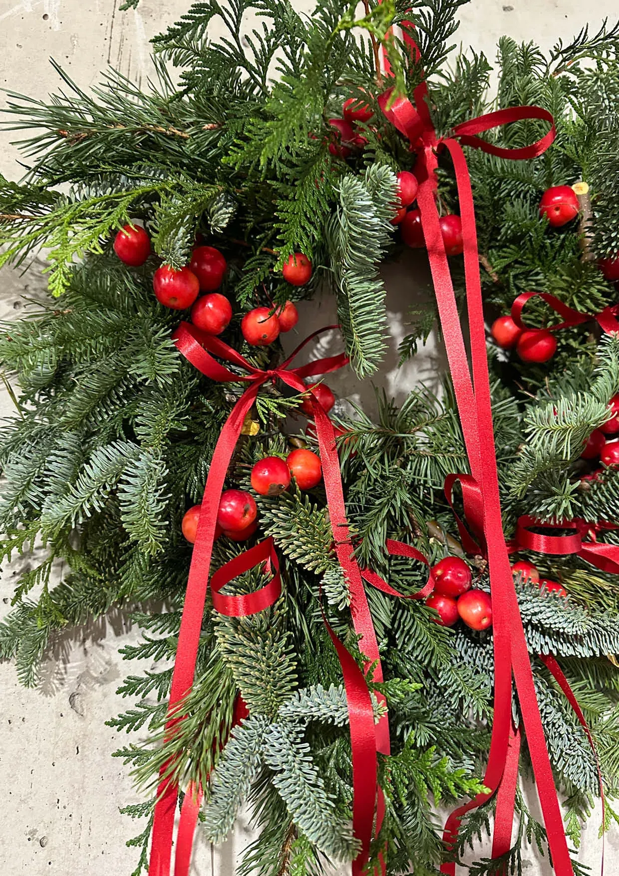 Christmas wreath with fir tree and red ribbon